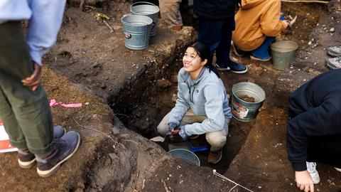 Students excavating in Harvard Yard