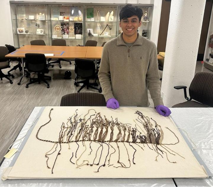 Sahil Jain with khipu 80.1012 in the Stanford University Archaeology Collections (photo by&nbsp;Veronica Jacobs-Edmondson).&nbsp;